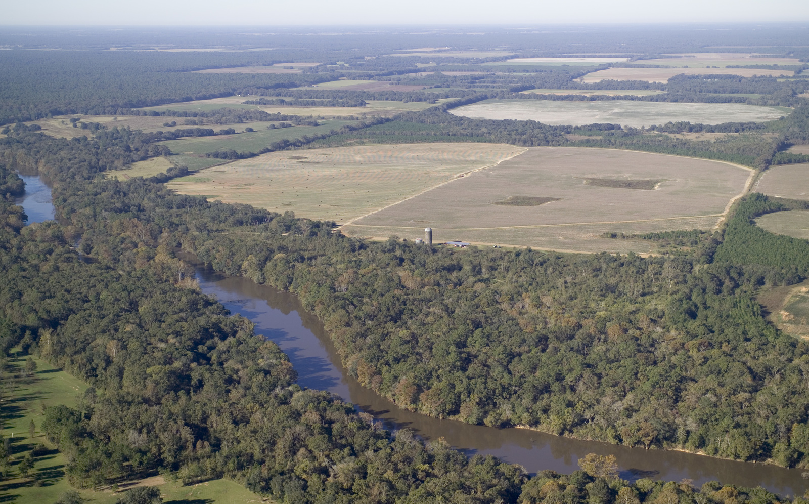 Aerial view of farmland, forest, and pivot irrigation systems